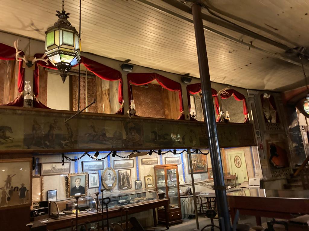Inside the main theatre and casino of the Bird Cage Theatre in Tombstone, AZ. The red-curtained balcony rooms on the top floor were brothel rooms.