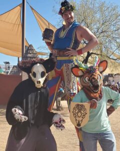 Goofy perfomer on stilts and a man dressed as a bear and another as a tiger at the Arizona Renaissance Festival.